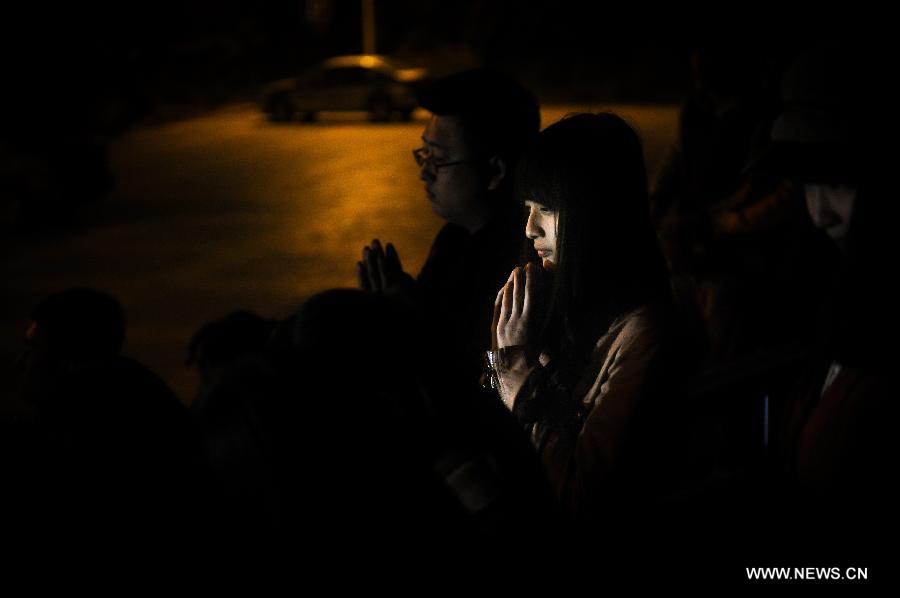 Students put the palms together while attending a vigil to express their well-wishes to people in quake-hit Ya'an in southwest China's Sichuan Province at Jilin University in Changchun, capital of northeast China's Jilin Province, April 20, 2013. A total of 156 people have been killed in the 7.0-magnitude earthquake in southwest China's Sichuan Province as of 8:50 p.m. Saturday, according to the China Earthquake Administration. (Xinhua/Xu Chang) 