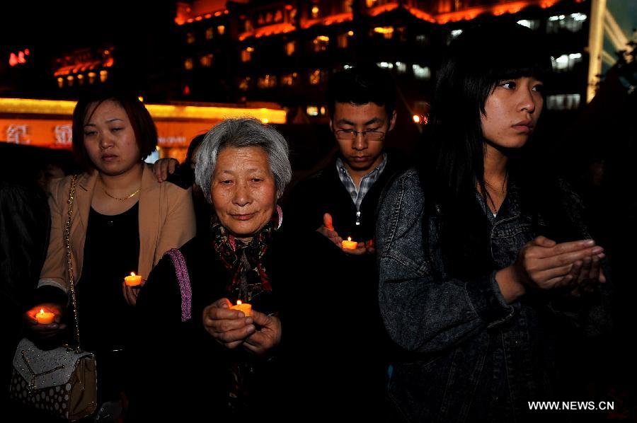 Citizens hold candles at a vigil to express their well-wishes to people in quake-hit Ya'an in southwest China's Sichuan Province at Jinhua Square in Xi'an, capital of northwest China's Shaanxi Province, April 20, 2013. A total of 156 people have been killed in the 7.0-magnitude earthquake in southwest China's Sichuan Province as of 8:50 p.m. Saturday, according to the China Earthquake Administration. (Xinhua/Liu Xiao) 