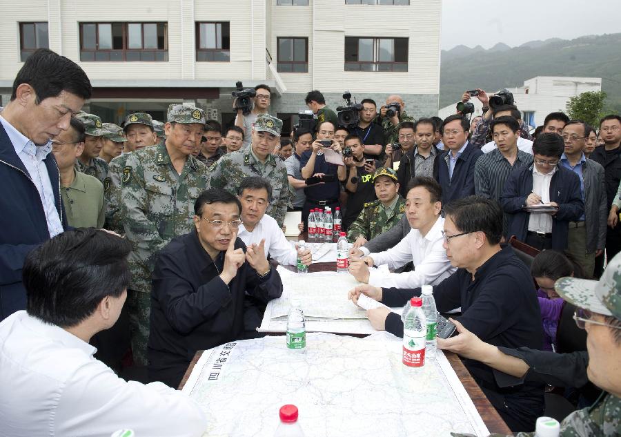Chinese Premier Li Keqiang, also a member of the Standing Committee of the Political Bureau of the Communist Party of China Central Committee, presides over a meeting at the severely-hit Longmen Township in the quake-hit Lushan County, southwest China's Sichuan Province, April 20, 2013. Li Keqiang arrived in Sichuan Saturday afternoon to deploy quake relief work. (Xinhua/Huang Jingwen)