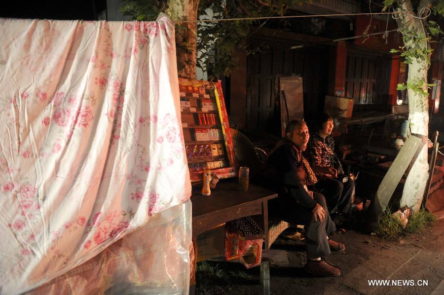 Citizens rest beside a road on the first night after the deadly earthquake in Lushan County in Ya'an City, southwest China's Sichuan Province, April 21, 2013. A 7.0-magnitude earthquake jolted Lushan County of Ya'an City on April 20 morning. Many citizens chose to spend the first night after the quake on roads or in temporary tents. (Xinhua/Luo Xiaoguang)    