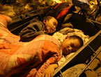 Children sleep on a tricycle after the deadly earthquake