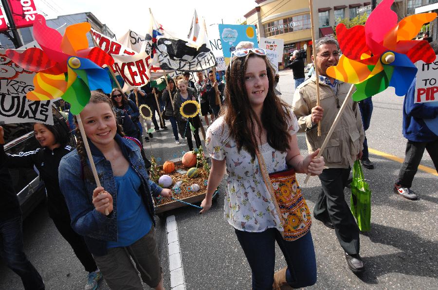 Students take part in annual Earth Day Parade and march through the streets of Vancouver, Canada, on April 20, 2013. This year's Earth Day Parade is organized by a group of high school students who call themselves "Youth 4 Climate Justice Now" in order to bring government attention to the environmental issues and to do more to leave youth with a sustainable world to inherit. (Xinhua/Sergei Bachlakov)