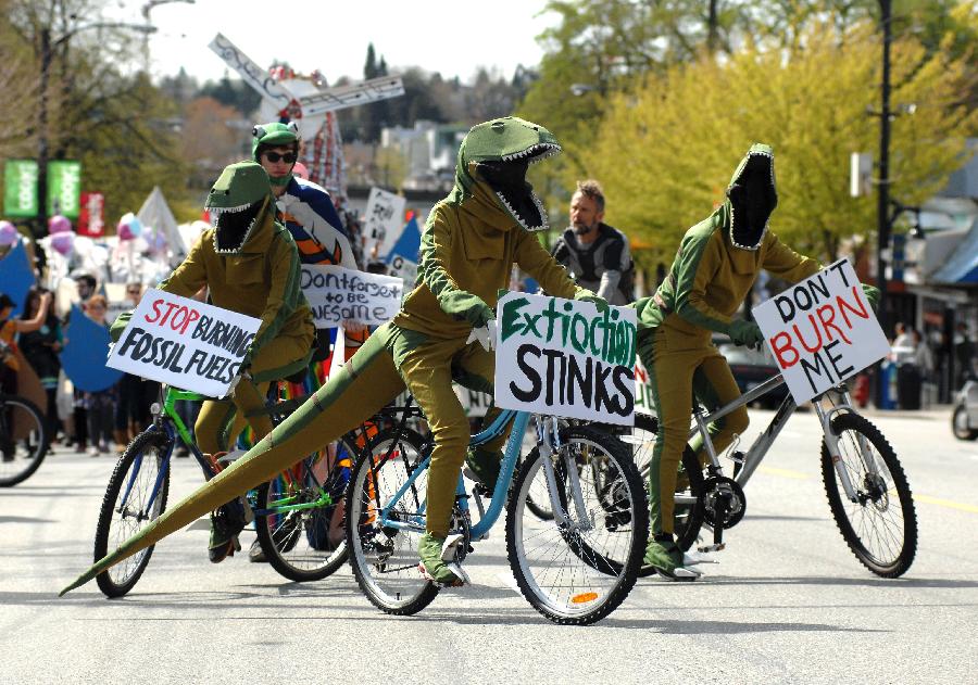 Activists dressed as dinosaurs take part in annual Earth Day Parade and march through the streets of Vancouver, Canada, on April 20, 2013. This year's Earth Day Parade is organized by a group of high school students who call themselves "Youth 4 Climate Justice Now" in order to bring government attention to the environmental issues and to do more to leave youth with a sustainable world to inherit. (Xinhua/Sergei Bachlakov)