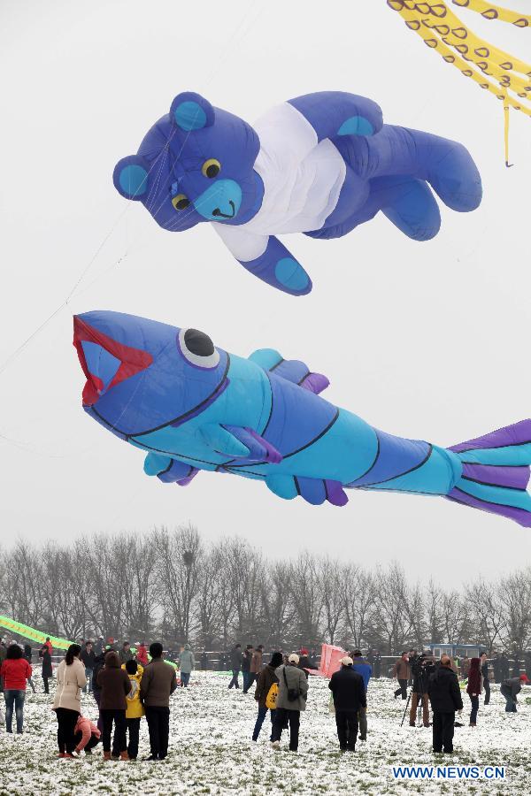 Participants fly kites at the 30th Weifang International Kite Festival in Weifang, east China's Shandong Province, April 20, 2013. Kite-making in Weifang, known as "Kite Capital," can be traced back to the late 16th century and the early 17th century. (Xinhua/Zhang Chi)