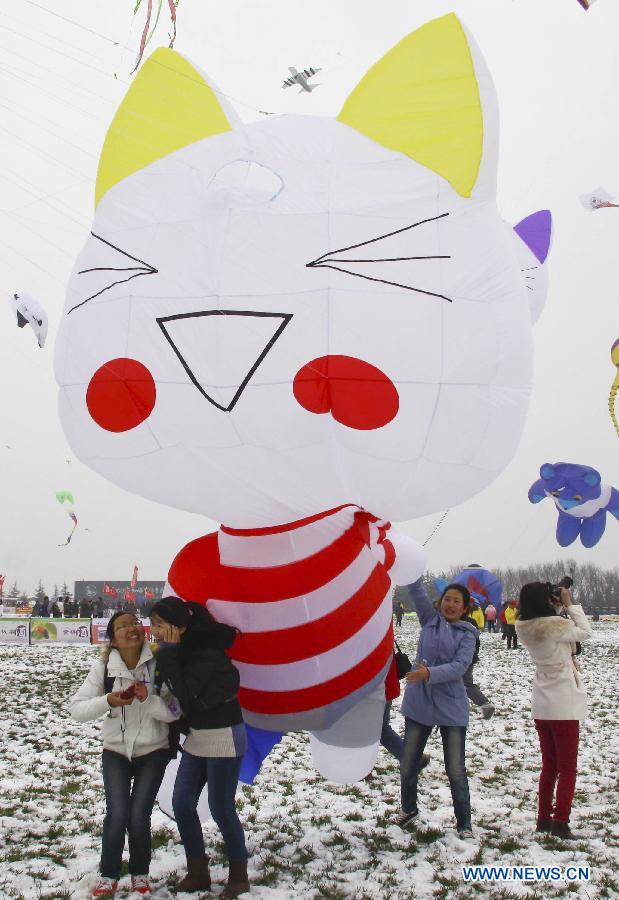 Participants fly kites at the 30th Weifang International Kite Festival in Weifang, east China's Shandong Province, April 20, 2013. Kite-making in Weifang, known as "Kite Capital," can be traced back to the late 16th century and the early 17th century. (Xinhua/Zhang Chi)