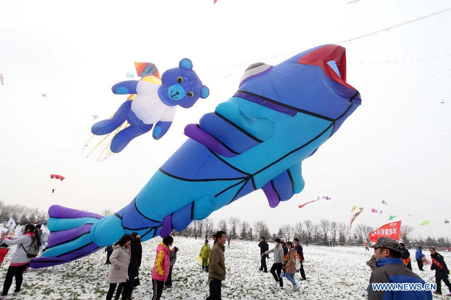 Participants fly kites at the 30th Weifang International Kite Festival in Weifang, east China's Shandong Province, April 20, 2013. Kite-making in Weifang, known as "Kite Capital," can be traced back to the late 16th century and the early 17th century. (Xinhua/Zhang Chi)