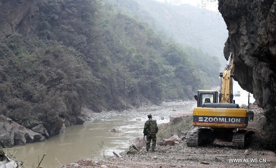 Armed police hydropower troops operate a bulldozer to repair a road leading to Baosheng Township, a worst quake-hit area, in Lushan County, southwest China's Sichuan Province, April 21, 2013. A 7.0-magnitude quake jolted Lushan County of Sichuan's Ya'an City at 8:02 a.m. Saturday Beijing Time, according to the China Earthquake Networks Center. Military and civilian rescue teams are struggling to reach every household in Lushan and neighboring counties. (Xinhua/Bai Xuefei) 