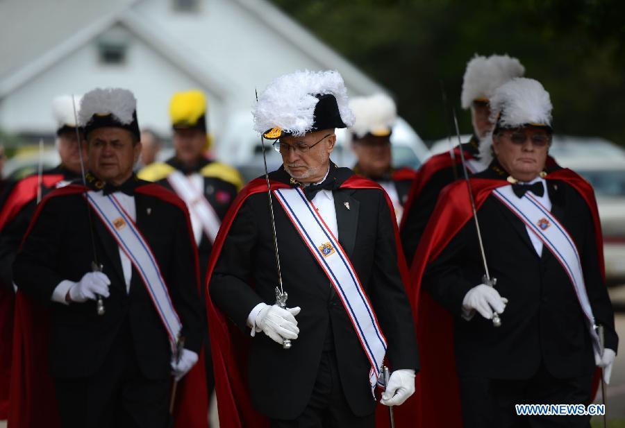 Members of the Knights of Columbus, one of the world's largest Catholic fraternal service organization, participate in a commemoration ceremony for the deceased people during the furtilizer explosion at a church in West, Texas, April 21, 2013. The powerful blast occurred around 7:50 p.m. local time Wednesday at the fertilizer plant in West, a small town some 320 km north of Houston, Texas, killing at least 14 people and injuring about 200 others. Another 60 remained unaccounted for in the blast, according to local officials. (Xinhua/Wang Lei) 