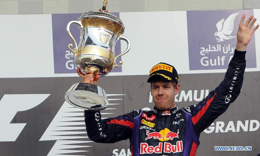 Red Bull driver Sebastian Vettel celebrates with the winner's trophy during the victory ceremony of the Bahrain F1 Grand Prix at the Bahrain International Circuit in Manama, Bahrain, on April 21, 2013. (Xinhua/Chen Shaojin)