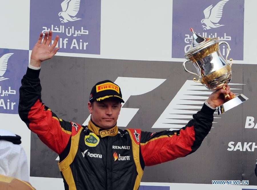 Lotus driver Kimi Raikkonen celebrates with the winner's trophy during the victory ceremony of the Bahrain F1 Grand Prix at the Bahrain International Circuit in Manama, Bahrain, on April 21, 2013. (Xinhua/Chen Shaojin)