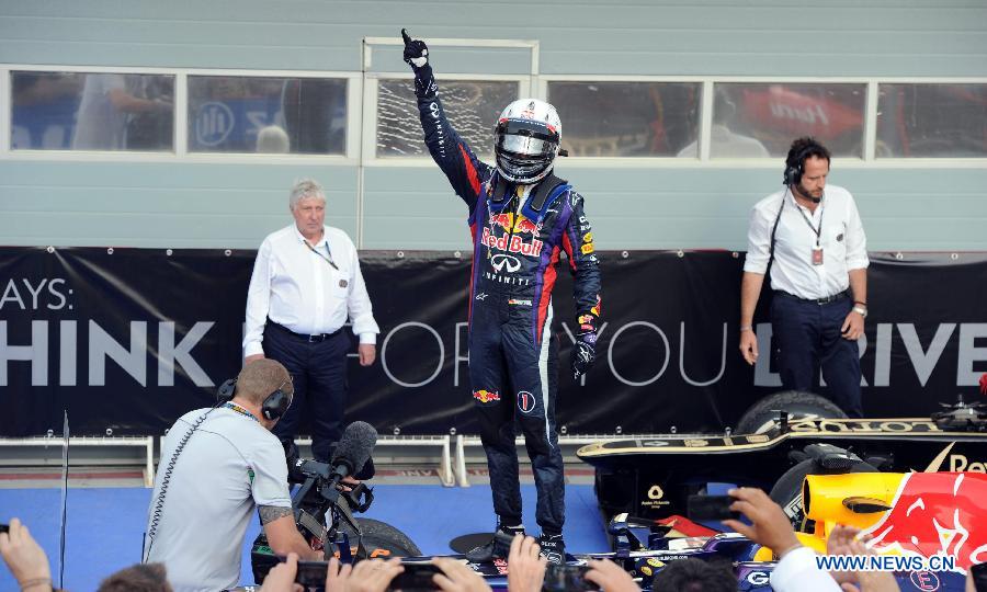Red Bull driver Sebastian Vettel celebrates during the victory ceremony of the Bahrain F1 Grand Prix at the Bahrain International Circuit in Manama, Bahrain, on April 21, 2013. (Xinhua/Chen Shaojin)