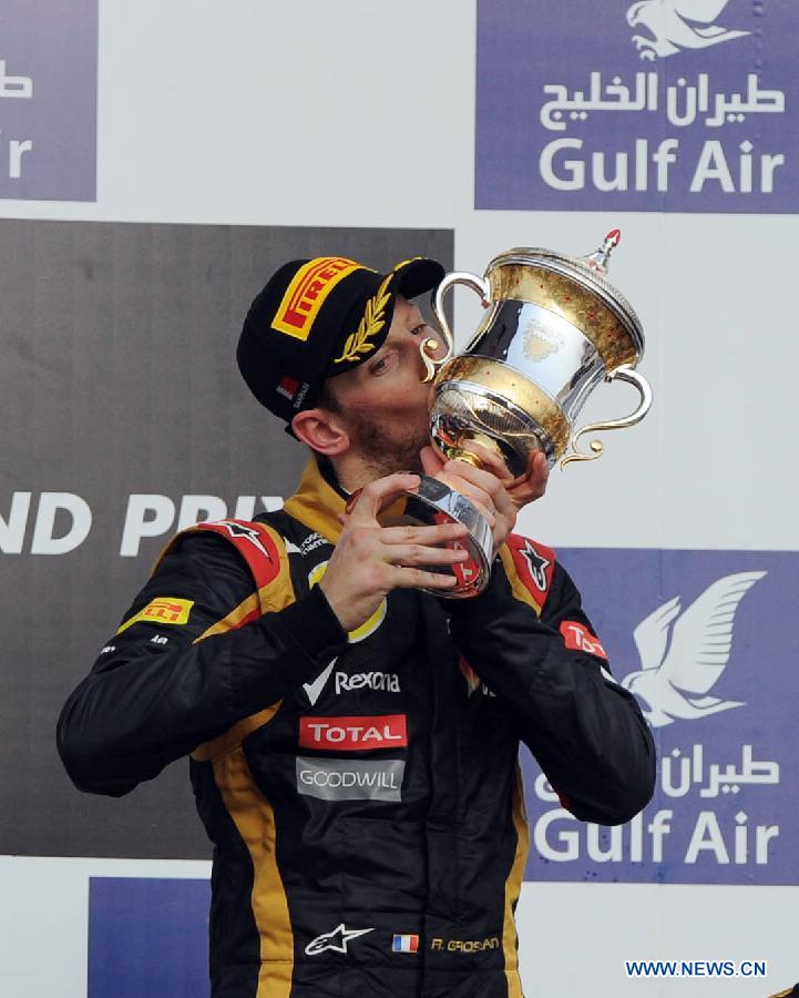 Lotus driver Romain Grosjean kisses the winner's trophy during the victory ceremony of the Bahrain F1 Grand Prix at the Bahrain International Circuit in Manama, Bahrain, on April 21, 2013. (Xinhua/Chen Shaojin)