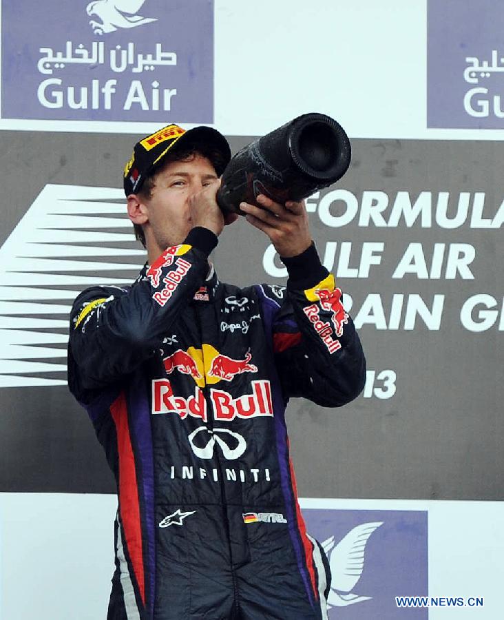 Red Bull driver Sebastian Vettel drinks champagne during the victory ceremony of the Bahrain F1 Grand Prix at the Bahrain International Circuit in Manama, Bahrain, on April 21, 2013. (Xinhua/Chen Shaojin)