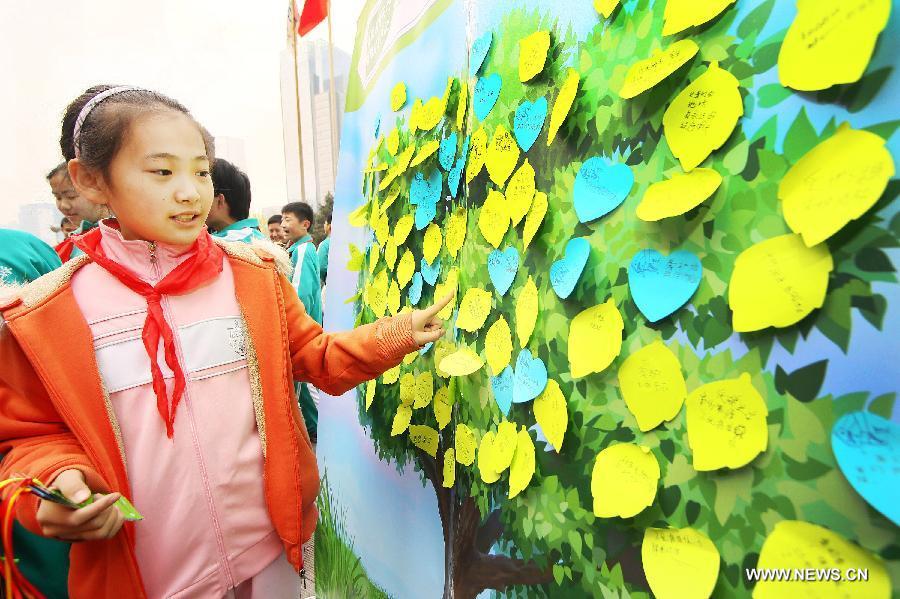 Photo taken on April 21, 2013 shows a girl during an environment protection activity in Beijing, capital of China. The environment protection activity was held to mark the World Earth Day, which falls on April 22 each year. (Xinhua/Yan Min)
