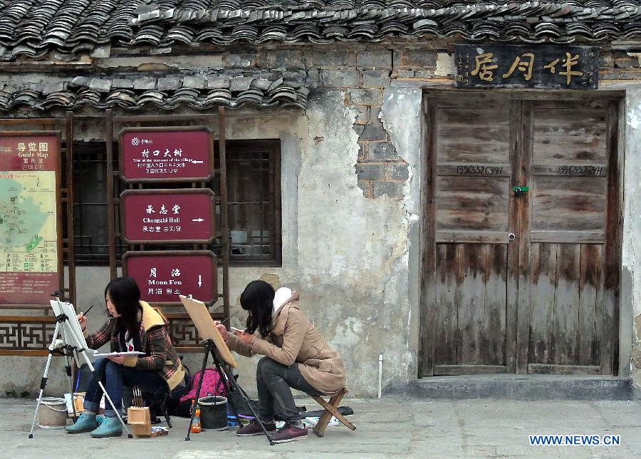 Students draw pictures in Hongcun Village, a famous tourist site in east China's Anhui Province, April 22, 2013. Hongcun, one of the UNESCO World Heritage Sites, took on beautiful spring view and attracted lots of art students. (Xinhua/Wang Song)