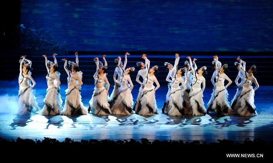 Artists of the Jilin Provincial Performing Troupe perform during a stage show at the Oriental Theatre in Changchun, capital of northeast China's Jilin Province, April 22, 2013. The show, with various art forms including singing, dancing, acrobatics and conjuring, displays folk customs in the Changbai Mountain area. (Xinhua/Xu Chang) 