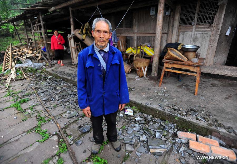 Villager Zhang Guiquan, 73, stands in front his house damaged by a strong earthquake in Yuxi Village, Baosheng Township, Lushan County, southwest China's Sichuan Province, April 22, 2013. A 7.0-magnitude quake shocked Lushan on April 20, and Baosheng is one of seriously affected areas. (Xinhua/Xiao Yijiu)
