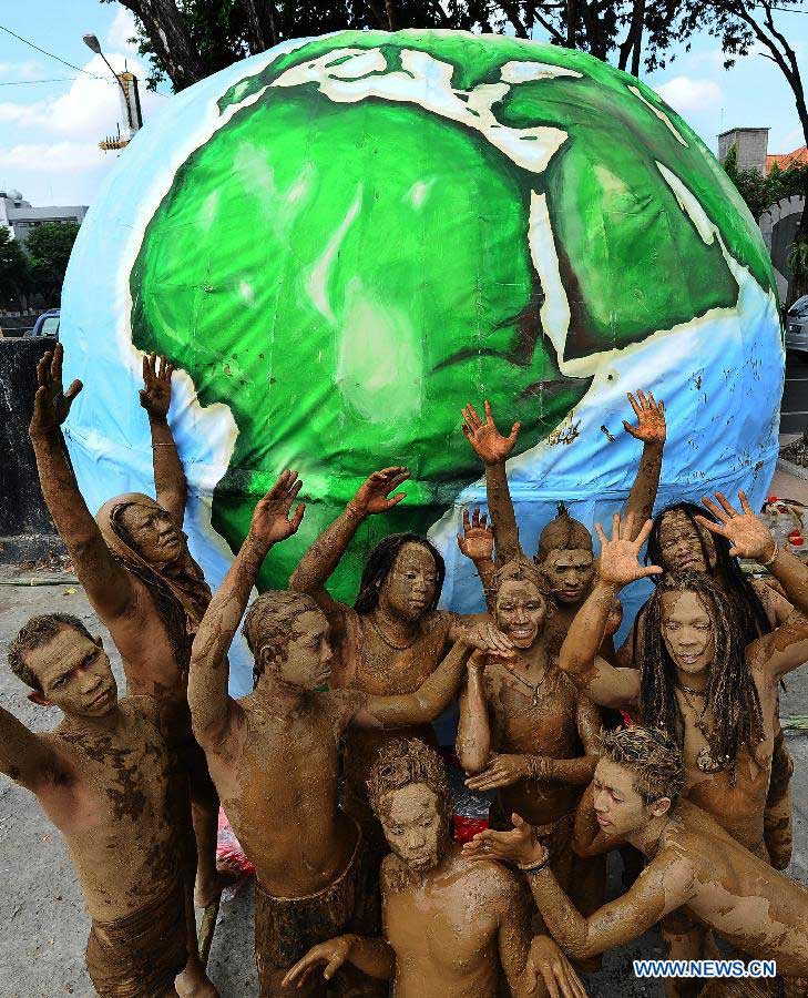 Environmental activists perform theatrical action during a parade to commemorate the Earth Day in Surabaya, Indonesia, April 22, 2013. In 2009, the UN General Assembly proclaimed April 22 as International Mother Earth Day to promote harmony with nature and the Earth. (Xinhua/Robert P) 