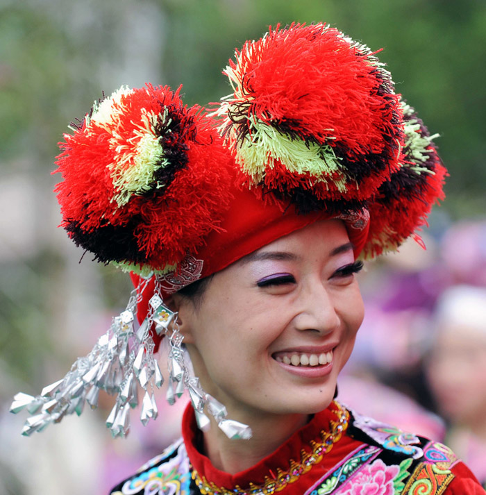 A woman dressed in festival costumes celebrates the Sanyuesan Festival in Shizong, Yunan province, April 12, 2013. (Xinhua/Yang Zongyou)