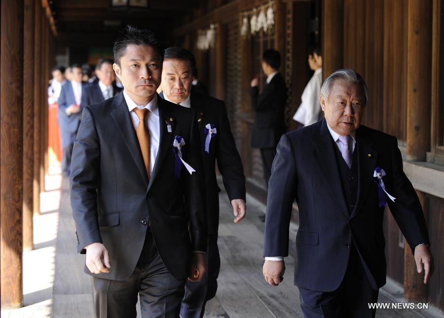 Japanese lawmakers head to visit the Yasukuni Shrine in Tokyo, Japan, on April 23, 2013. Despite repeated strong opposition from China, a group of 168 Japanese lawmakers on Tuesday visited the controversial war-link Yasukuni Shrine in Tokyo, which honors Japanese war criminals of World War II. It marked the first time that the Japanese lawmakers' number exceeded 100 since October 2005, according to local media. (Xinhua) 