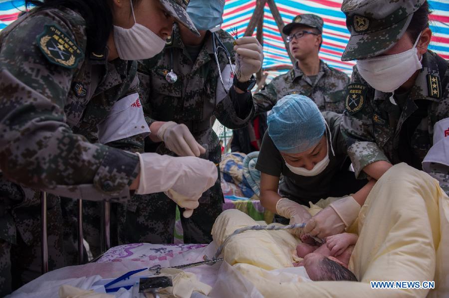 Medical workers take care of a newborn boy in a tent functioned as temporary hospital in quake-hit Taiping Township of Lushan County, southwest China's Sichuan Province, April 23, 2013. The newborn baby was named Chen Qirui, and both mother and baby were fine. The boy's mother Yang Yan, a 20-year-old woman, and father Chen Wei arrived at the hospital in the early morning on Tuesday, after taking a long journey for over three hours from their home in Xingmin Village of the Taiping Township. This was the fourth day after a 7.0-magnitude earthquake jolted Lushan County on April 20. (Xinhua/Chen Cheng)