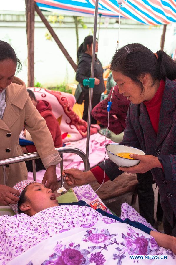Yang Yan, a 20-year-old new mother, is helped to eat eggs after giving birth to a boy in a tent functioned as temporary hospital in quake-hit Taiping Township of Lushan County, southwest China's Sichuan Province, April 23, 2013. Both mother and baby were fine. Yang and her husband Chen Wei arrived at the hospital in the early morning on Tuesday, after taking a long journey for over three hours from their home in Xingmin Village of the Taiping Township. This was the fourth day after a 7.0-magnitude earthquake jolted Lushan County on April 20. (Xinhua/Liu Jinhai)