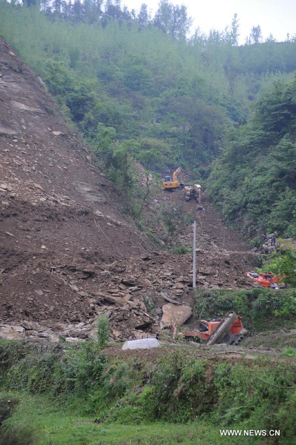 Excavators search for victims of a landslide in Qinggangpo Township of Sinan County, southwest China's Guizhou Province, April 23, 2013. Nine people died, two were injured and another two were missing following a landslide that occurred at 10:42 p.m on Monday when construction workers were repairing a road damaged by a previous landslide in Sinan County. The rescue operation is underway. (Xinhua/Tao Liang)  