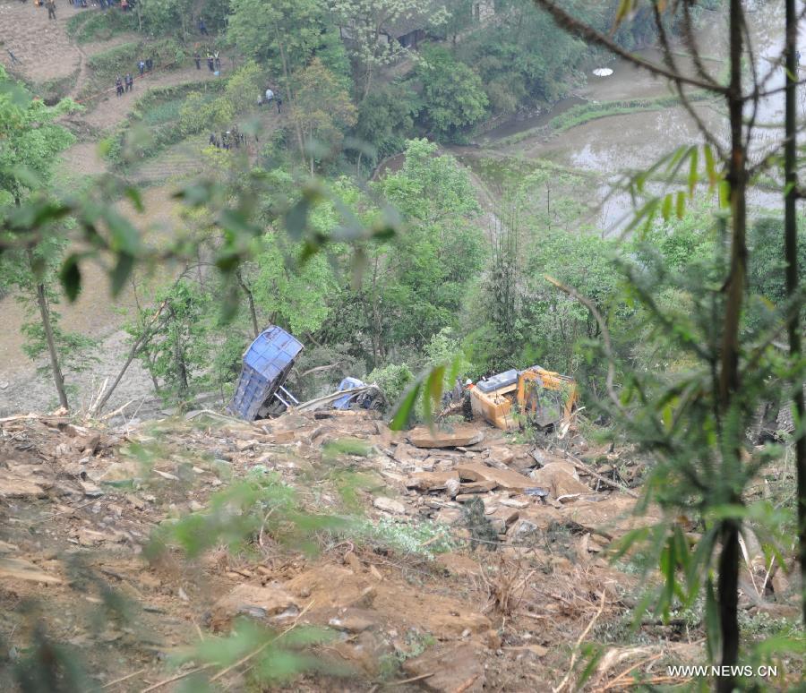 An excavator searches for victims of a landslide in Qinggangpo Township of Sinan County, southwest China's Guizhou Province, April 23, 2013. Nine people died, two were injured and another two were missing following a landslide that occurred at 10:42 p.m on Monday when construction workers were repairing a road damaged by a previous landslide in Sinan County. The rescue operation is underway. (Xinhua/Tao Liang) 