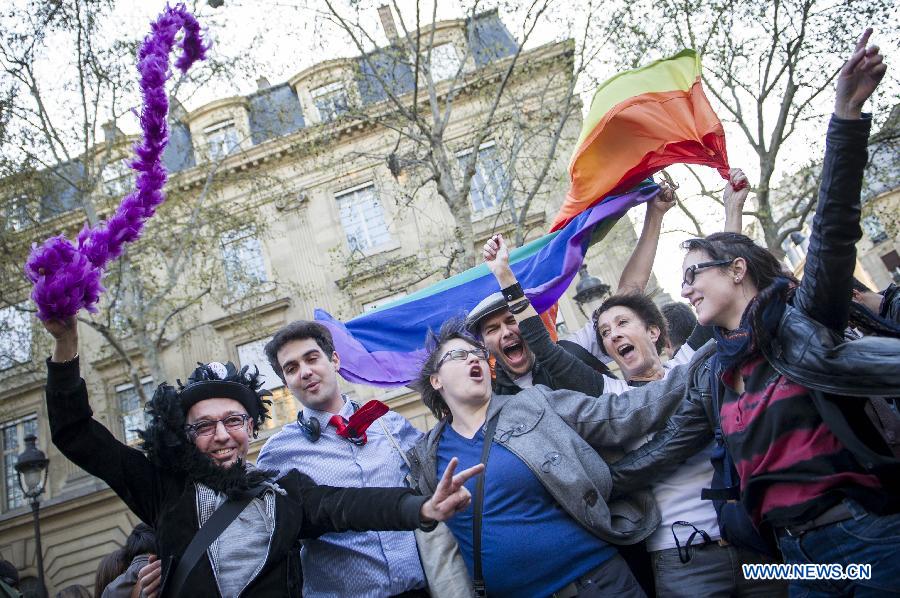 Supporters celebrate after France's legislators give the green light to same-sex couples to marry and adopt children in Paris, April 23, 2013. As the ruling Socialist Party (PS) enjoys an absolute majority at the National Assembly where 331 legislators voted for the bill and 225 voted against, it successfully paved the way for France to join dozens of other countries, mostly in Europe, to allow same-sex unions and adoption.(Xinhua/Etienne Laurent)