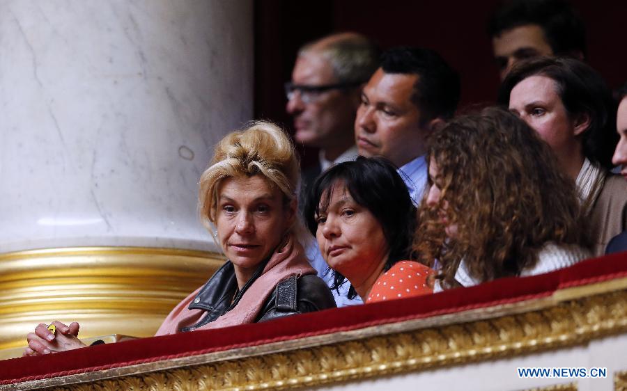 Anti same-sex marriage leader Frigide Barjot watches after the passing of the vote on same-sex marriage at the French Parliament in Paris, France, April 23, 2013. As the ruling Socialist Party (PS) enjoys an absolute majority at the National Assembly where 331 legislators voted for the bill and 225 voted against, it successfully paved the way for France to join dozens of other countries, mostly in Europe, to allow same-sex unions and adoption.(Xinhua/Etienne Laurent)