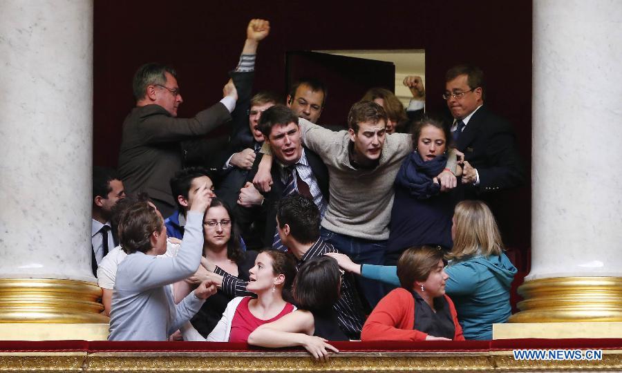 Anti same-sex marriage protesters clash with left-wing legislators after the passing of the vote on same-sex marriage at the French Parliament in Paris, France, April 23, 2013. As the ruling Socialist Party (PS) enjoys an absolute majority at the National Assembly where 331 legislators voted for the bill and 225 voted against, it successfully paved the way for France to join dozens of other countries, mostly in Europe, to allow same-sex unions and adoption.(Xinhua/Etienne Laurent)