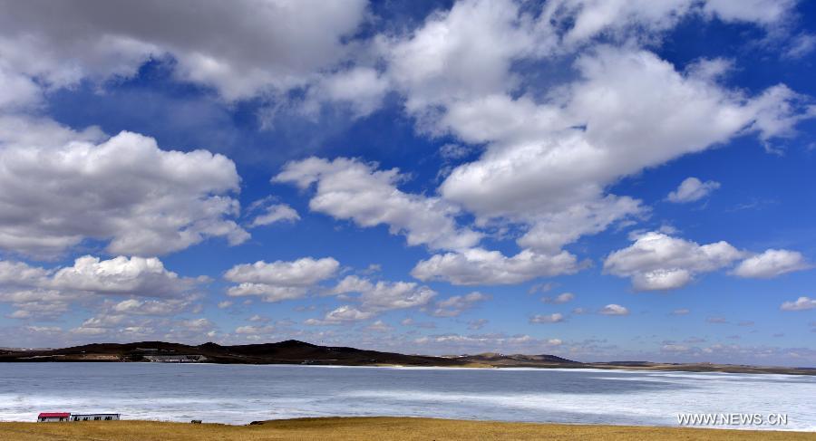 Photo taken on April 23, 2013 shows the scenery of a reservoir covered with snow and ice in Ulgai, north China's Inner Mongolia Autonomous Region. (Xinhua/Ren Junchuan)