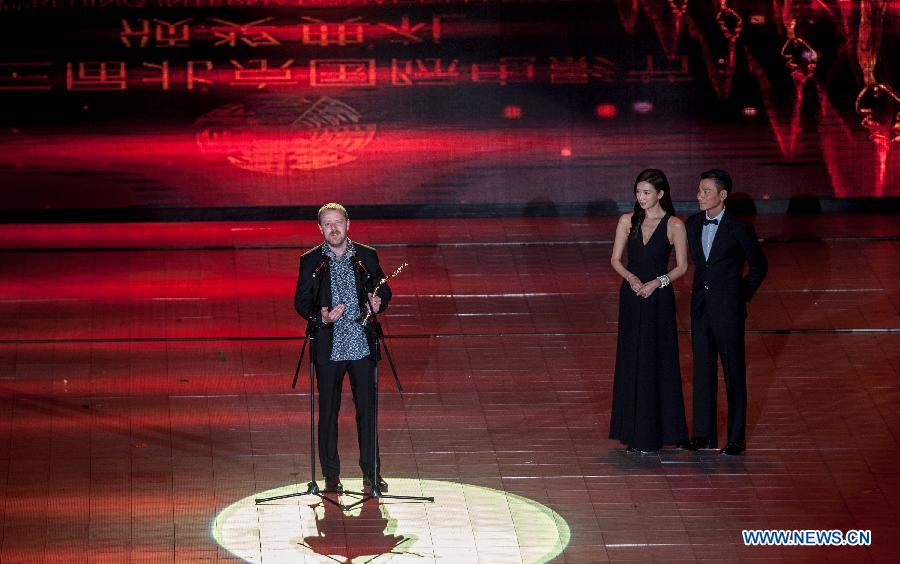 A cast member of the movie "Song for Marion", as a representative of British actor Terence Stamp, receives the trophy for the Tiantan Award of Best Actor during the closing ceremony of the 2013 Beijing International Film Festival in Beijing, capital of China, April 23, 2013. The festival closed on Tuesday. (Xinhua/Zhang Yu) 