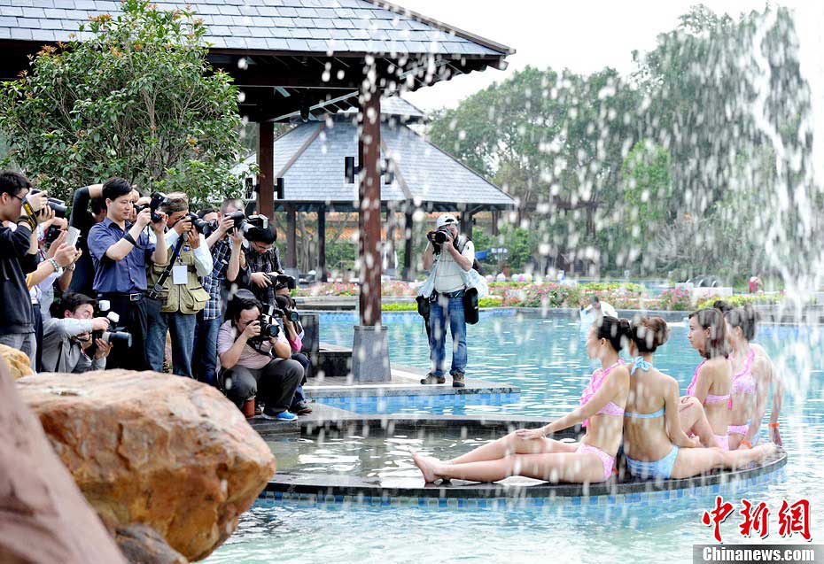 Photographers take photos of the beauties participating in Miss Bikini Global Pageant 2013 during location shooting in Zhongshan, south China's Guangdong province on April 23, 2013. (CNSPHOTO/ Liu Weiyong)