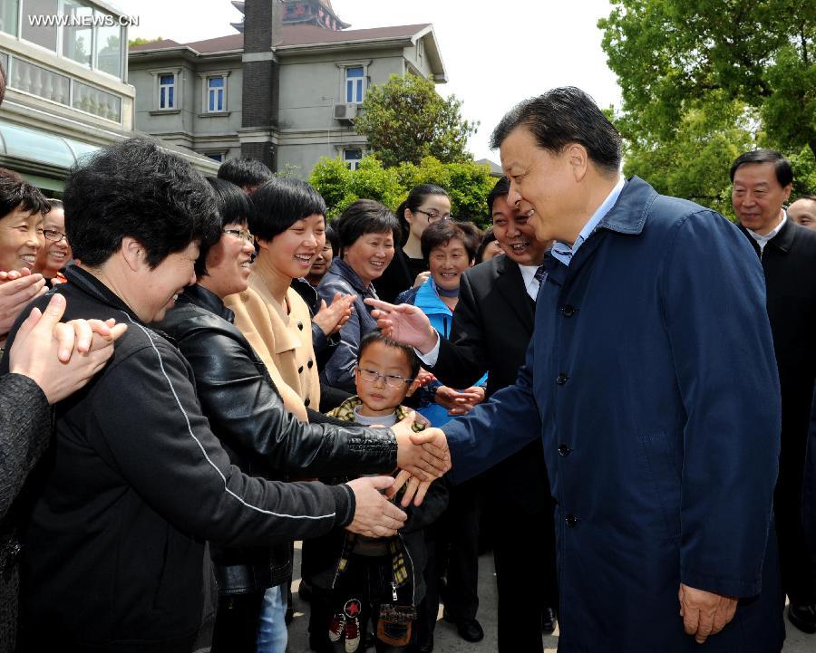 Liu Yunshan (R, front), a member of the Standing Committee of the Political Bureau of the Communist Party of China (CPC) Central Committee and member of the Secretariat of the CPC Central Committee, shakes hands with local residents in Huaxixinshi Village in Jiangyin, east China's Jiangsu Province, April 21, 2013. Liu Yunshan made an inspection tour in Jiangsu from April 20 to 22. (Xinhua/Rao Aimin) 