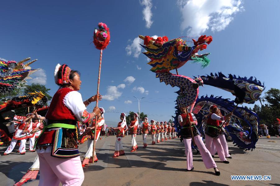 People in traditional costumes dance to celebrate the opening of March Street Festival in Dali Bai Autonomous Prefecture, southwest China's Yunnan Province , April 24, 2013. The 2013 Dali March Street Festival, opening each year on March 15 of Chinese Lunar calendar, is a traditional carnival of Bai ethnic group containing folk art and sports activity and merchandise expo. (Xinhua/Qin Qing)