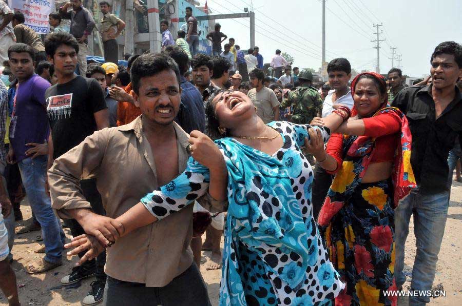 A woman cries as her relative died after a building collapsed in Savar, Bangladesh, April 24, 2013. At least 70 people were killed and over six hundred injured after an eight-storey building in Savar on the outskirts of the Bangladeshi capital Dhaka collapsed on Wednesday morning. (Xinhua/Shariful Islam) 
