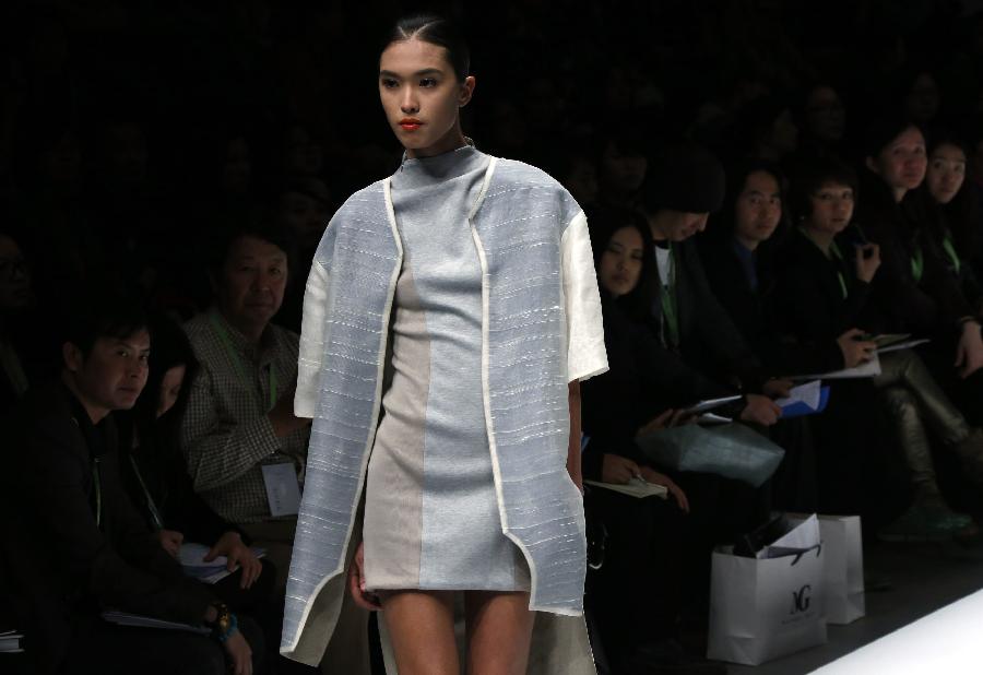 A model presents a creation designed by students from the Sino-French Institute of Fashion Designer in Shanghai University of Engineering Science during the first China Graduate Fashion Week in Beijing, capital of China, April 24, 2013. A total of 610 graduate students of fashion from 22 colleges will present their designs during the five-day event which kicked off on Wednesday. (Xinhua/Li Mingfang)