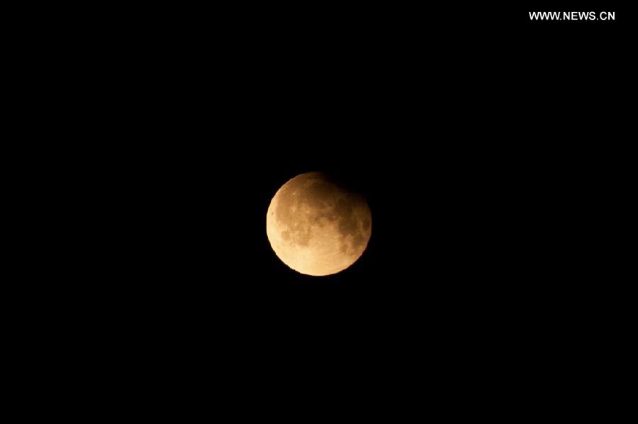 Photo taken on April 26, 2013 shows a partial lunar eclipse over the sky of Beijing, capital of China. The earth casts a shadow on the face of the moon and makes the partial lunar eclipse. (Xinhua/Zhang Cheng) 