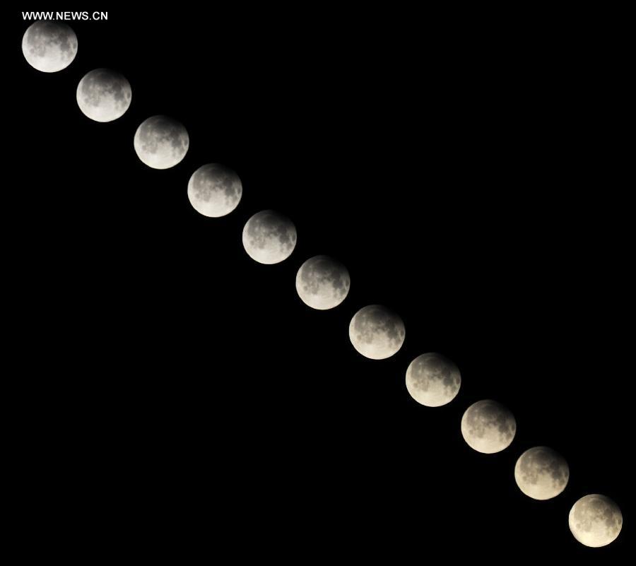 Combination photo taken on April 26, 2013 shows a partial lunar eclipse over the sky of Tianjin, north China. The earth casts a shadow on the face of the moon and makes the partial lunar eclipse. (Xinhua/Yue Yuewei)
