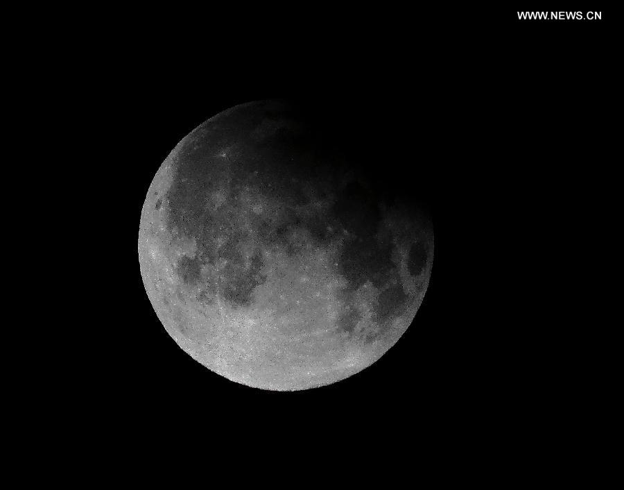 Photo taken on April 26, 2013 shows a partial lunar eclipse over the sky of Beijing, capital of China. The earth casts a shadow on the face of the moon and makes the partial lunar eclipse. (Xinhua/Li Xin) 