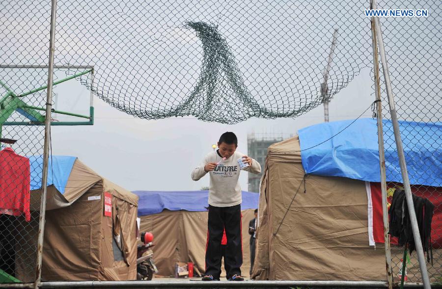 A boy brushes teeth at a temporary settlement for quake-affected people in Lushan Middle School in Lushan County, southwest China's Sichuan Province, April 26, 2013. A 7.0-magnitude jolted Lushan County on April 20. (Xinhua/Li Wen) 