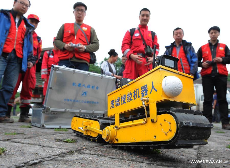 Staff members operate a rescue robot in Ya'an City, southwest China's Sichuan Province, April 24, 2013. The deformable robot, created by Shenyang Institute of Automation of Chinese Academy of Sciences, has been put into use in assisting the search tasks during the Lushan Earthquake. (Xinhua/Li Ziheng) 