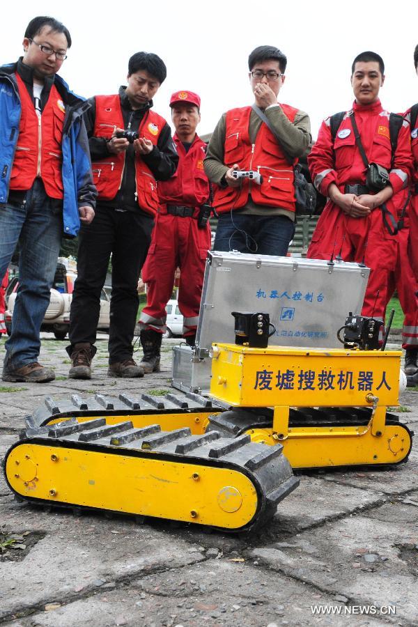 Staff members operate a rescue robot in Ya'an City, southwest China's Sichuan Province, April 24, 2013. The deformable robot, created by Shenyang Institute of Automation of Chinese Academy of Sciences, has been put into use in assisting the search tasks during the Lushan Earthquake. (Xinhua/Li Ziheng) 