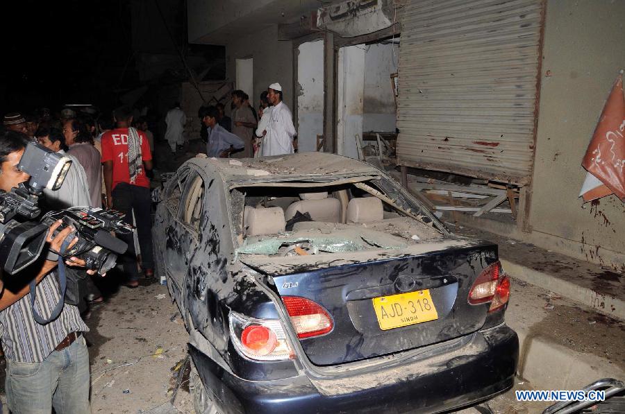 A damaged vehicle is seen at the blast site in southern Pakistani port city of Karachi on April 26, 2013. At least 11 people including a child were killed and 40 others injured on Friday night in a bomb blast that targeted a political meeting in Pakistan's southern port city of Karachi, local media and police said. (Xinhua/Masroor)