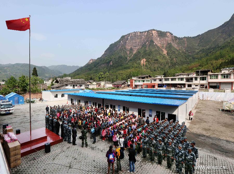 Students and soldiers from the air force attend a flag-raising ceremony in Baosheng Primary School in Lushan County, southwest China's Sichuan Province, April 26, 2013. The primary school was built within 28 hours by the air force troops from the People's Liberation Army (PLA) Chengdu Military Area Command (MAC), who also donated stationery and computers to students and teachers affected by the earthquake which hit Lushan County on April 20. (Xinhua/Liu Yinghua)