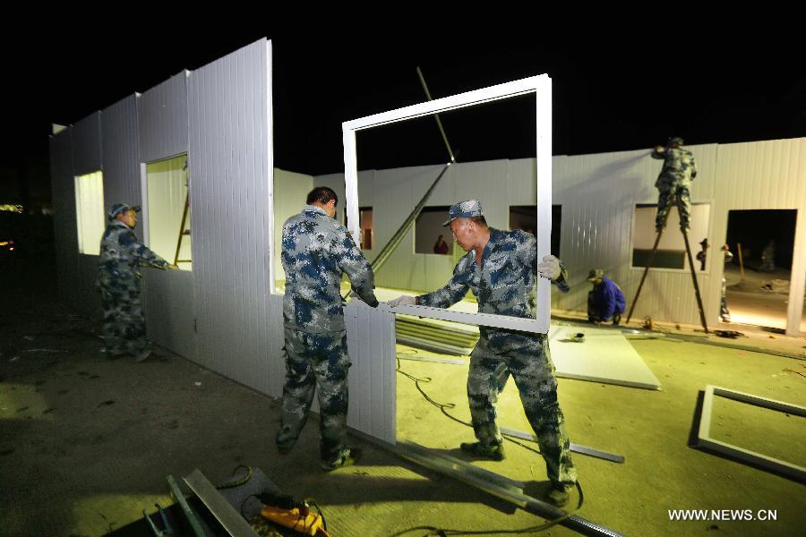 Soldiers from the air force build classrooms for students in Baosheng Primary School in Lushan County, southwest China's Sichuan Province, April 25, 2013. The primary school was built within 28 hours by the air force troops from the People's Liberation Army (PLA) Chengdu Military Area Command (MAC), who also donated stationery and computers to students and teachers affected by the earthquake which hit Lushan County on April 20. (Xinhua/Liu Yinghua)