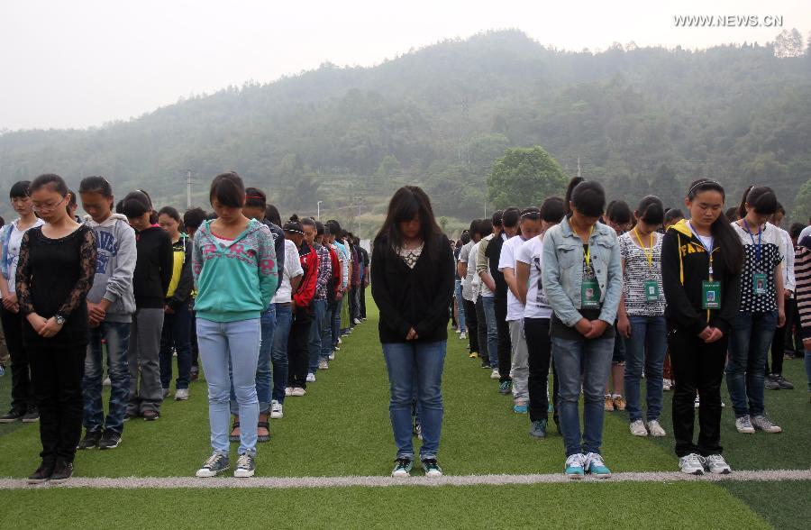 Teachers and students mourn for those who died in a 7.0-magnitude quake a week ago, at Lushan Middle School in Lushan County, southwest China's Sichuan Province, April 27, 2013. Public mourning was held on Saturday morning in Sichuan Province for those who died in a 7.0-magnitude quake a week ago. The earthquake hit Lushan County of Sichuan Province on April 20 and has claimed nearly 200 lives. (Xinhua/Xue Yubin)