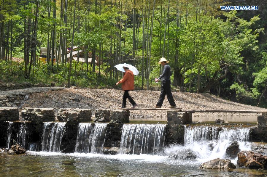 Tourists walk at a scenic spot in Jingxian County, Xuancheng City, east China's Anhui Province, April 26, 2013. (Xinhua/Guo Chen) 