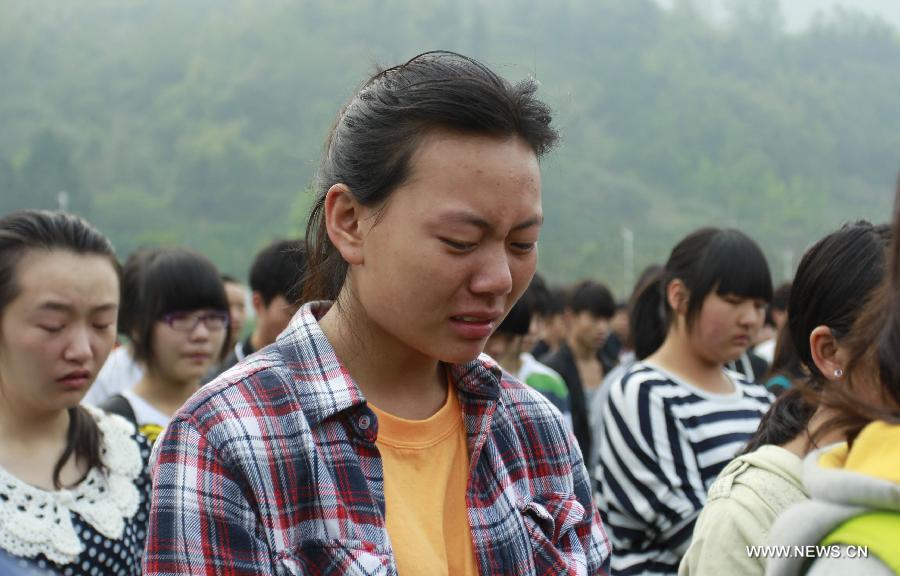 A student cries as mourning for those who died in a 7.0-magnitude quake a week ago, at the playground of Lushan Middle School in Lushan County, Ya'an City, southwest China's Sichuan Province, April 27, 2013. Public mourning was held on Saturday morning in Sichuan Province for those who died in the earthquake on April 20. The quake has claimed nearly 200 lives. (Xinhua/Zhou Qiang)
